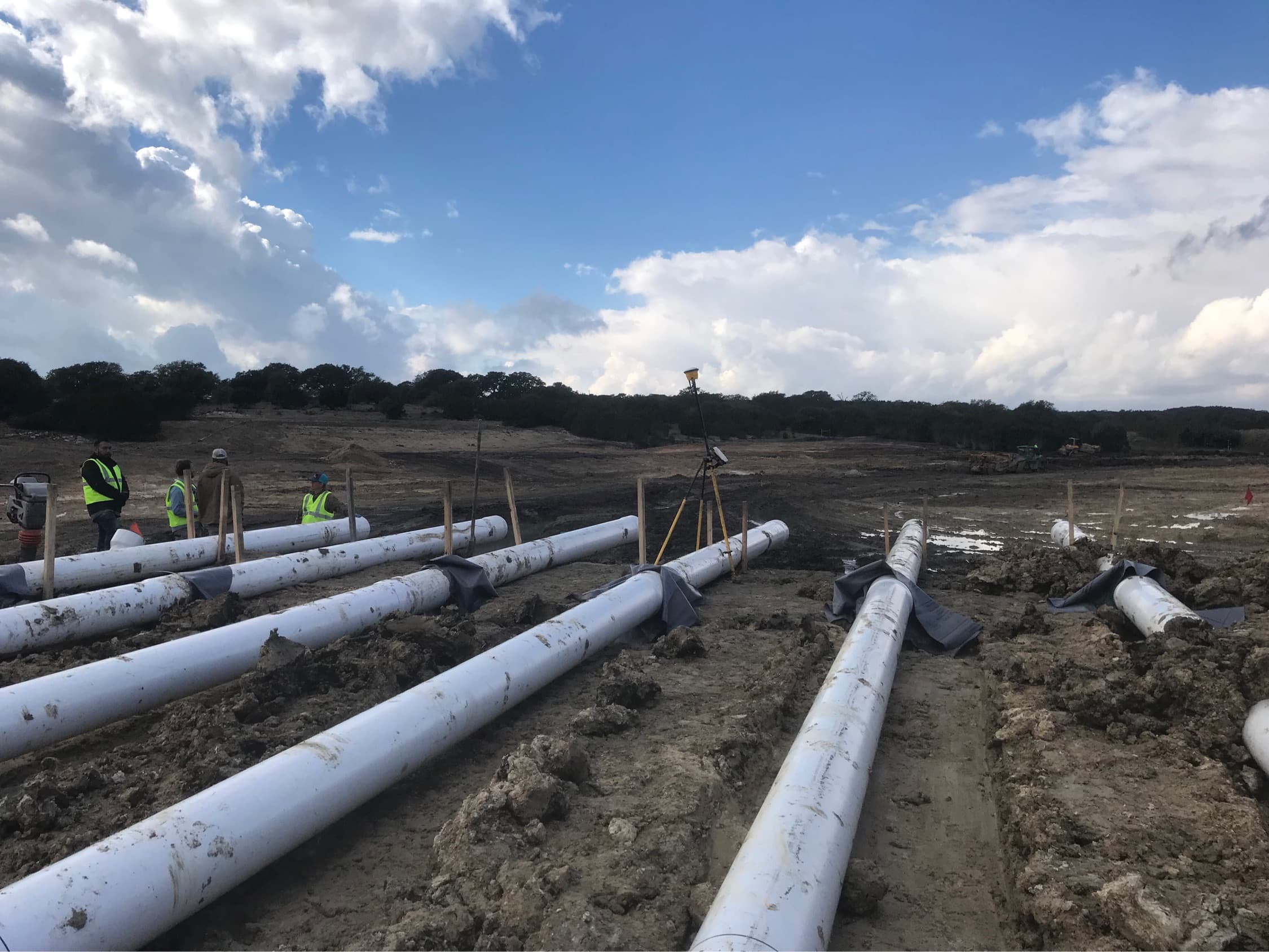 Rolling a liner across the pond bed
