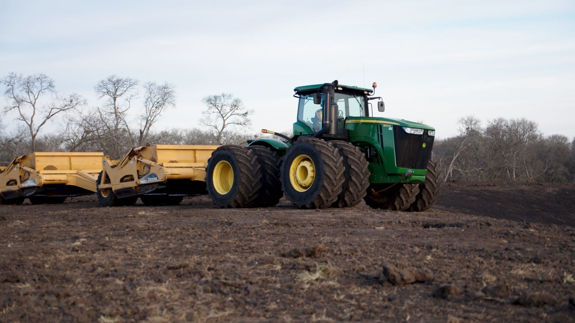 A tractor renovating rural ranch land